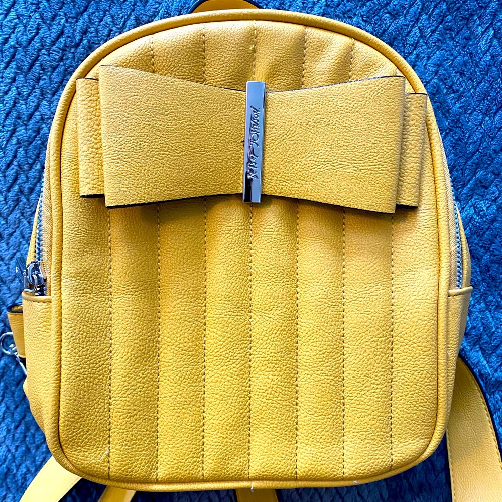 Betsy Johnson yellow bow mini backpack.